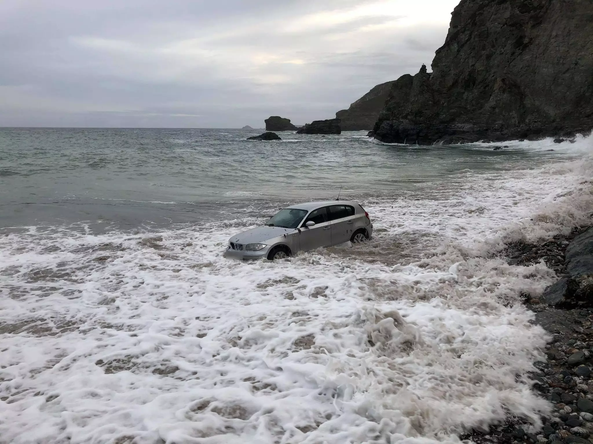 The car became trapped on St Agnes beach in Cornwall.