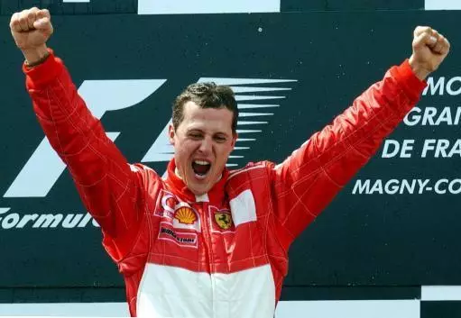 Michael Schumacher celebrates after winning the French Formula One Grand Prix on the Magny-Cours racetrack in France, 21 July 2002.