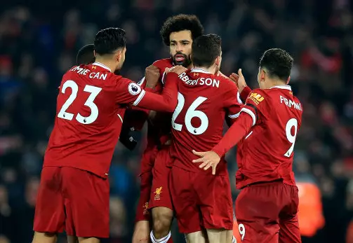 Liverpool players surround Mohamed Salah after his glorious goal. Image: PA