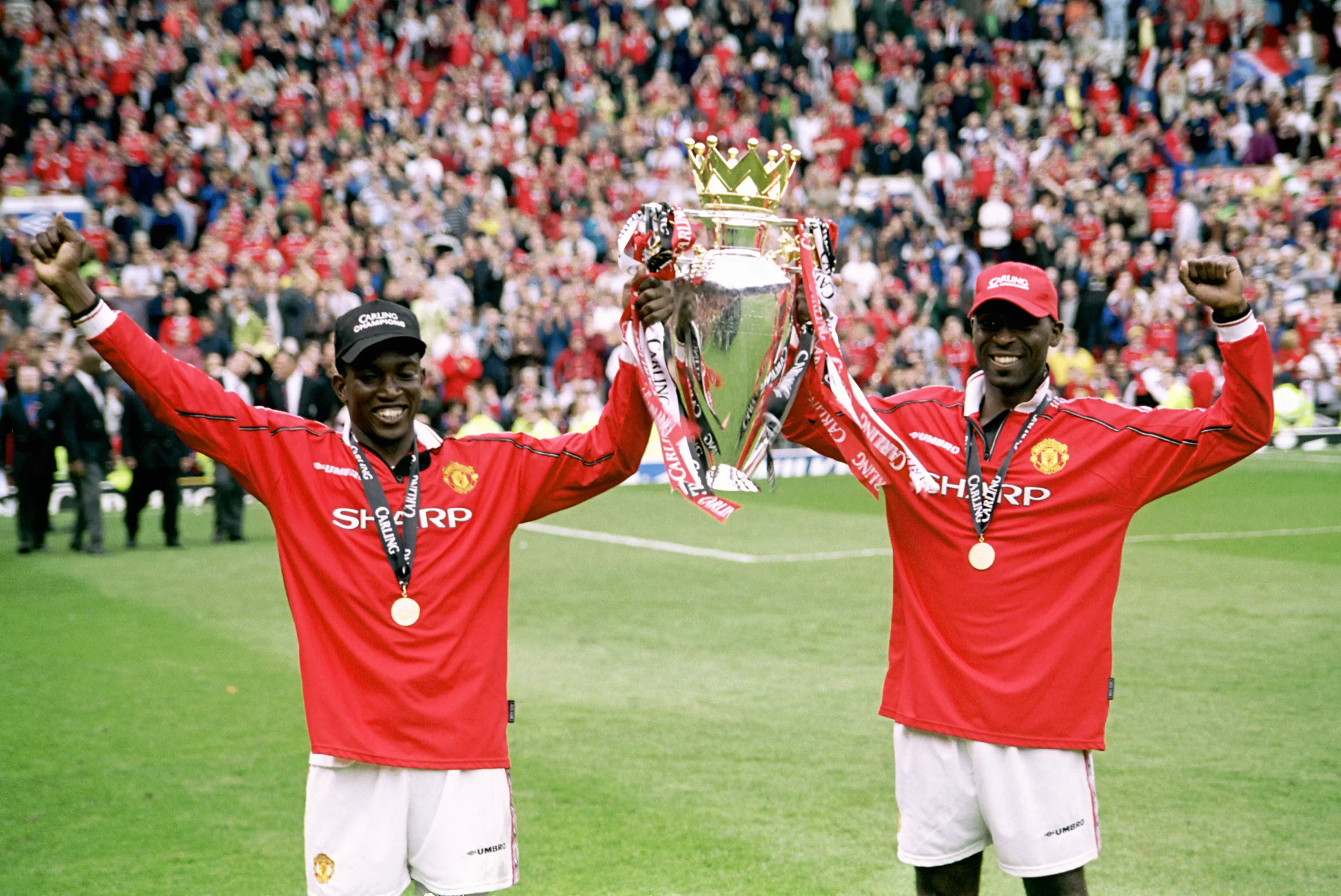 Cole with strike partner Dwight Yorke after his winner against Spurs captured the title. Image: PA Images