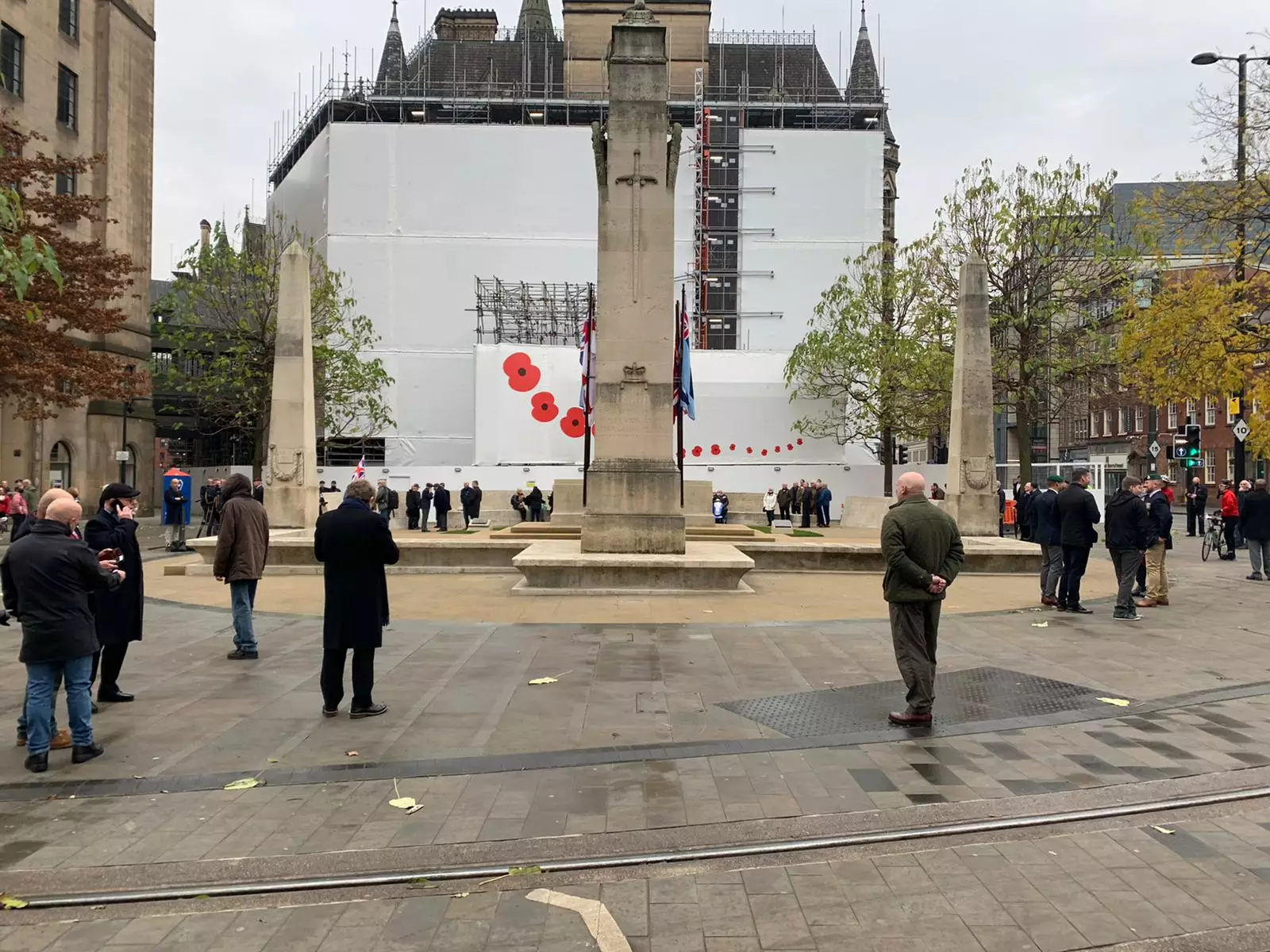 People social distance as they pay tribute at Manchester Cenotaph.