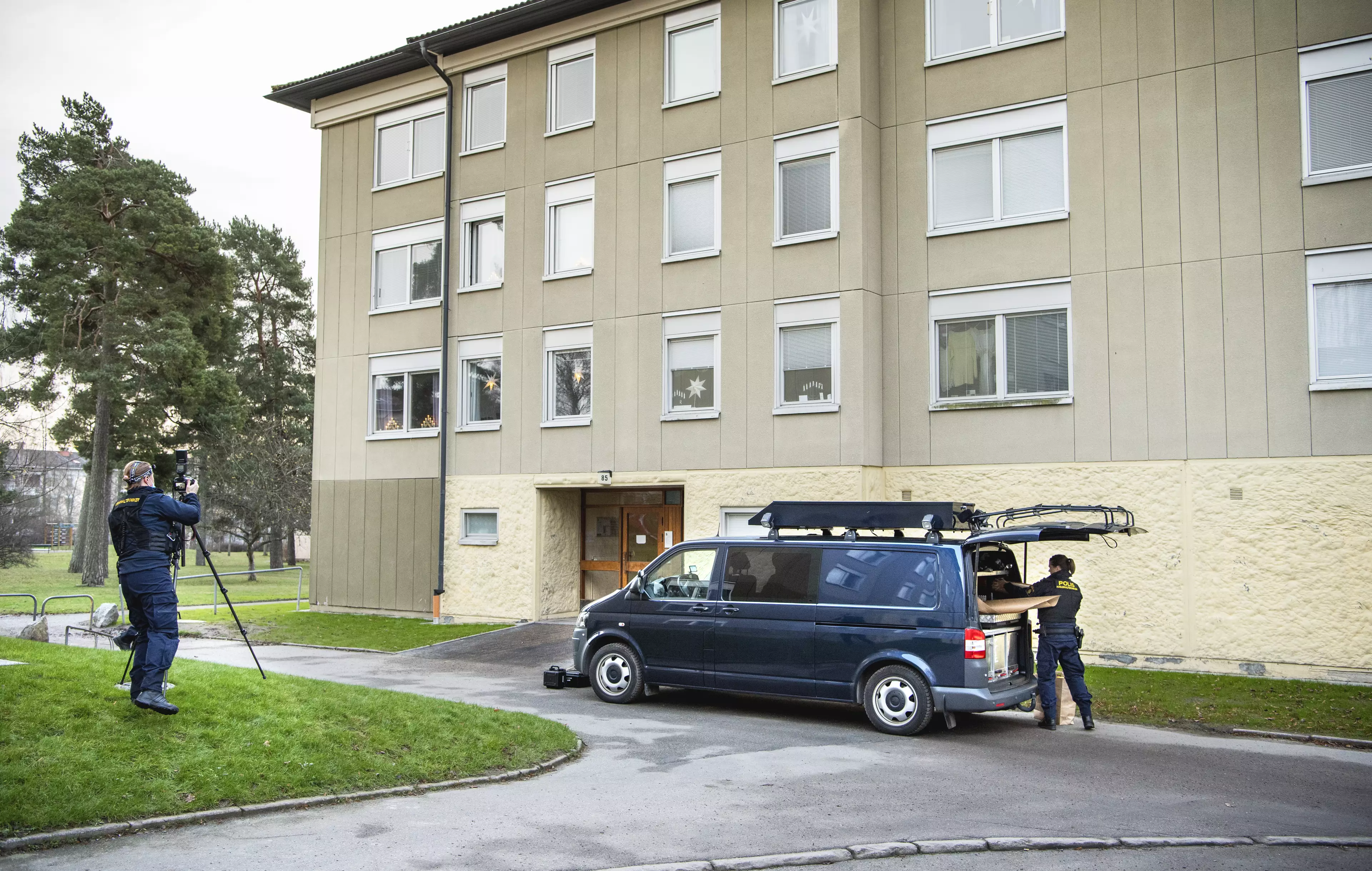 Police at the scene of the apartment where a woman is suspected of locking up her son, in Haninge, south of Stockholm.