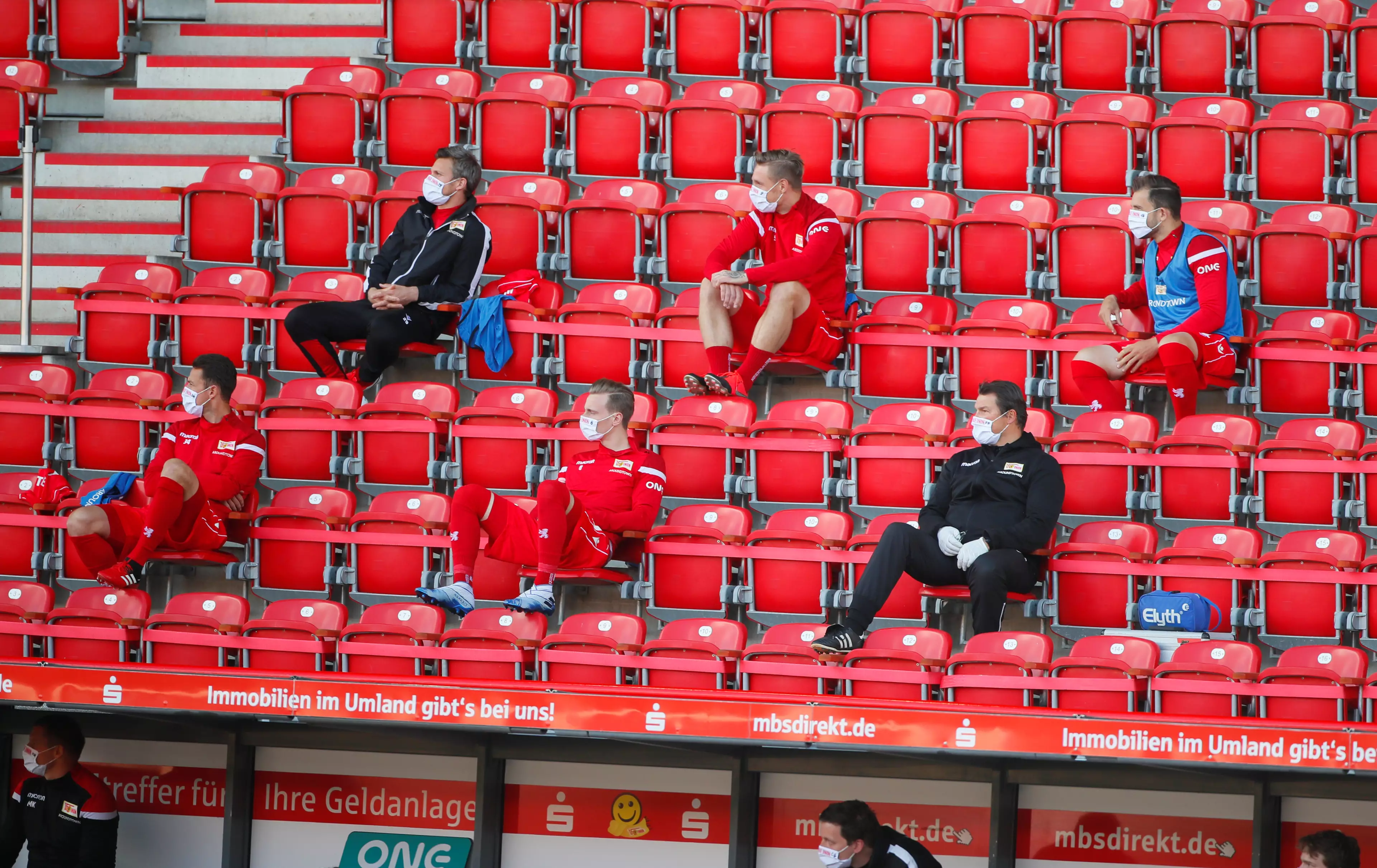 Substitutes and coaches social distancing during the game. Image: PA Images