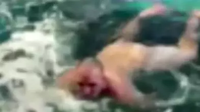 Footage Shows Naked Man Jumping Into A Shark Tank