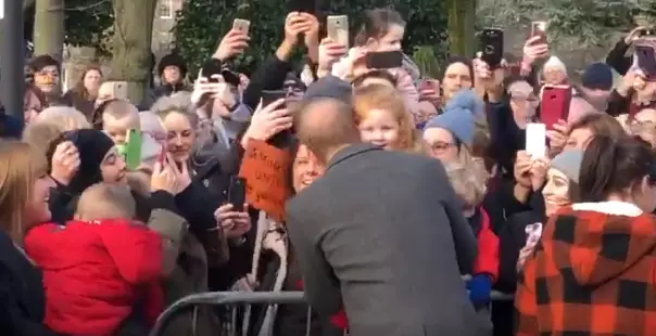 Prince Harry Hugging The Little Girl.