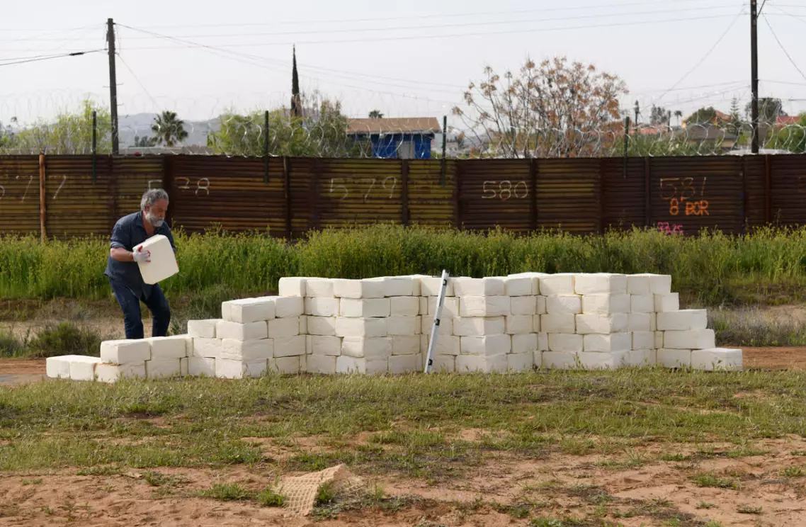 The artist plans to build a 1,000-foot wall made entirely of cheese.