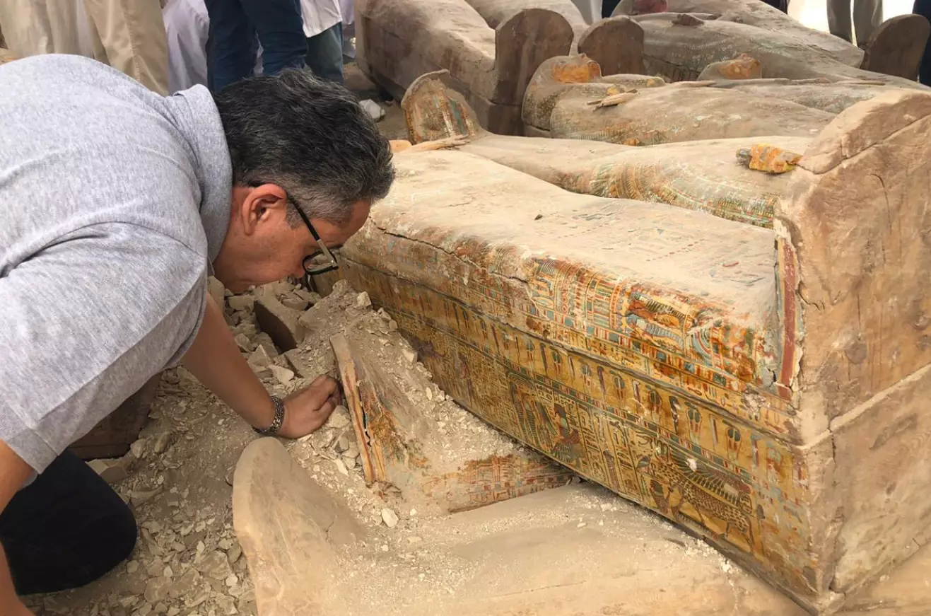 Egyptian Minister of Antiquities, Khaled el-Anany, inspecting the coffins.
