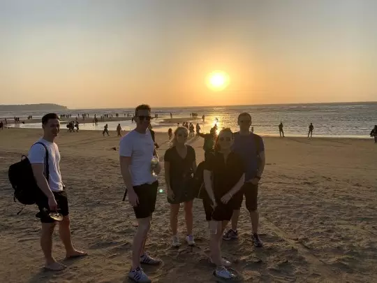 The team enjoying the sunset at a beach.