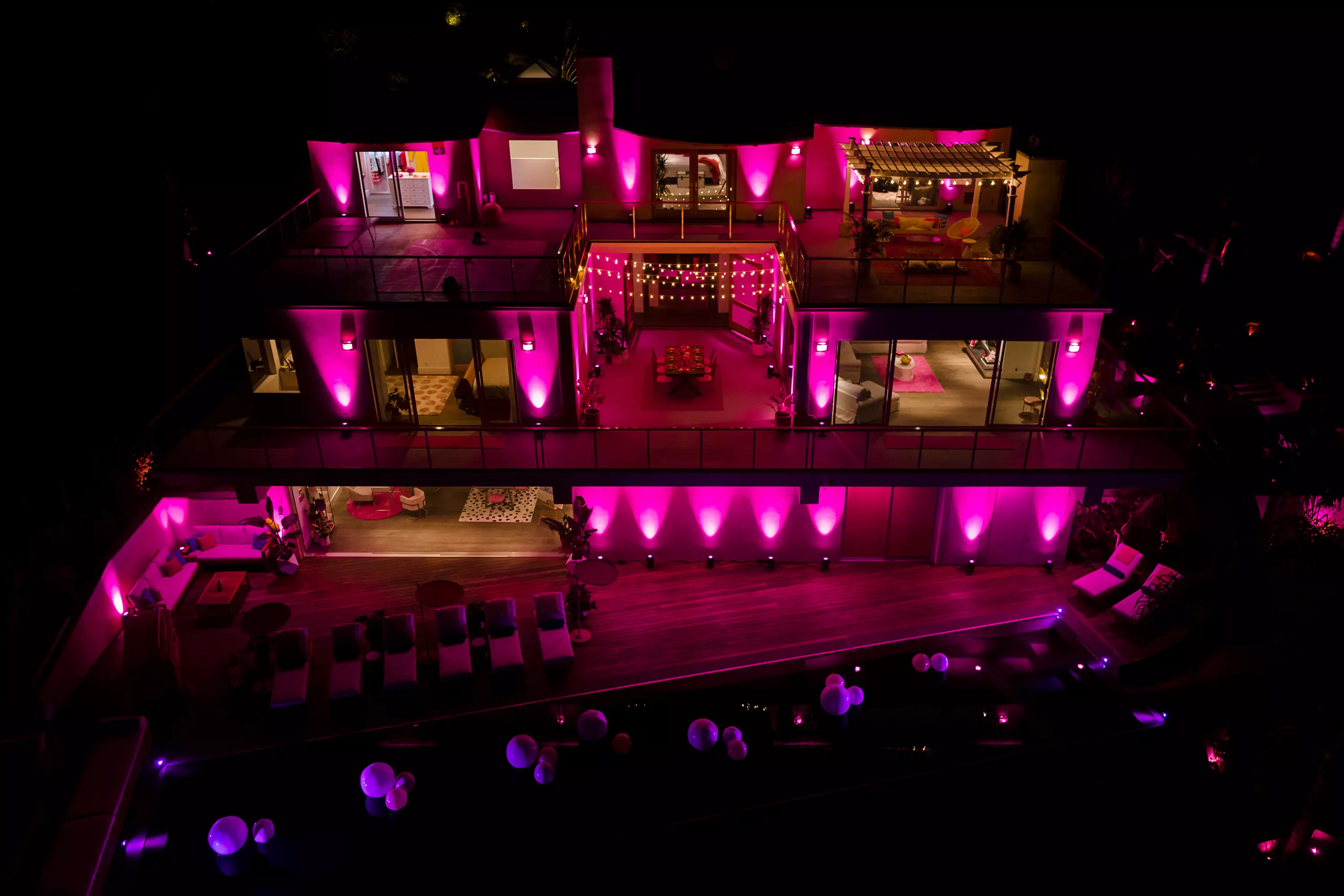 The home illuminates pink at night. (
