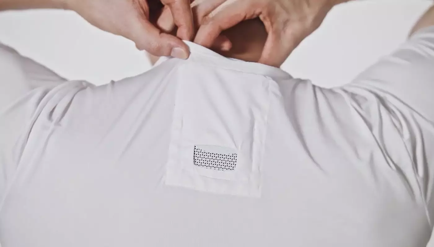 The device fits into the back of a specially made t-shirt.
