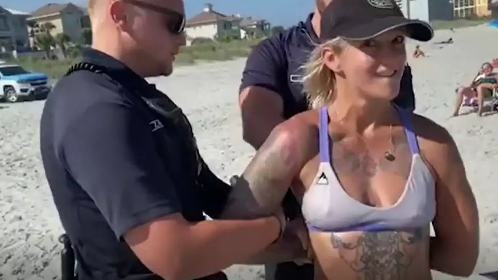 Woman Handcuffed On Beach For Wearing Thong Bikini