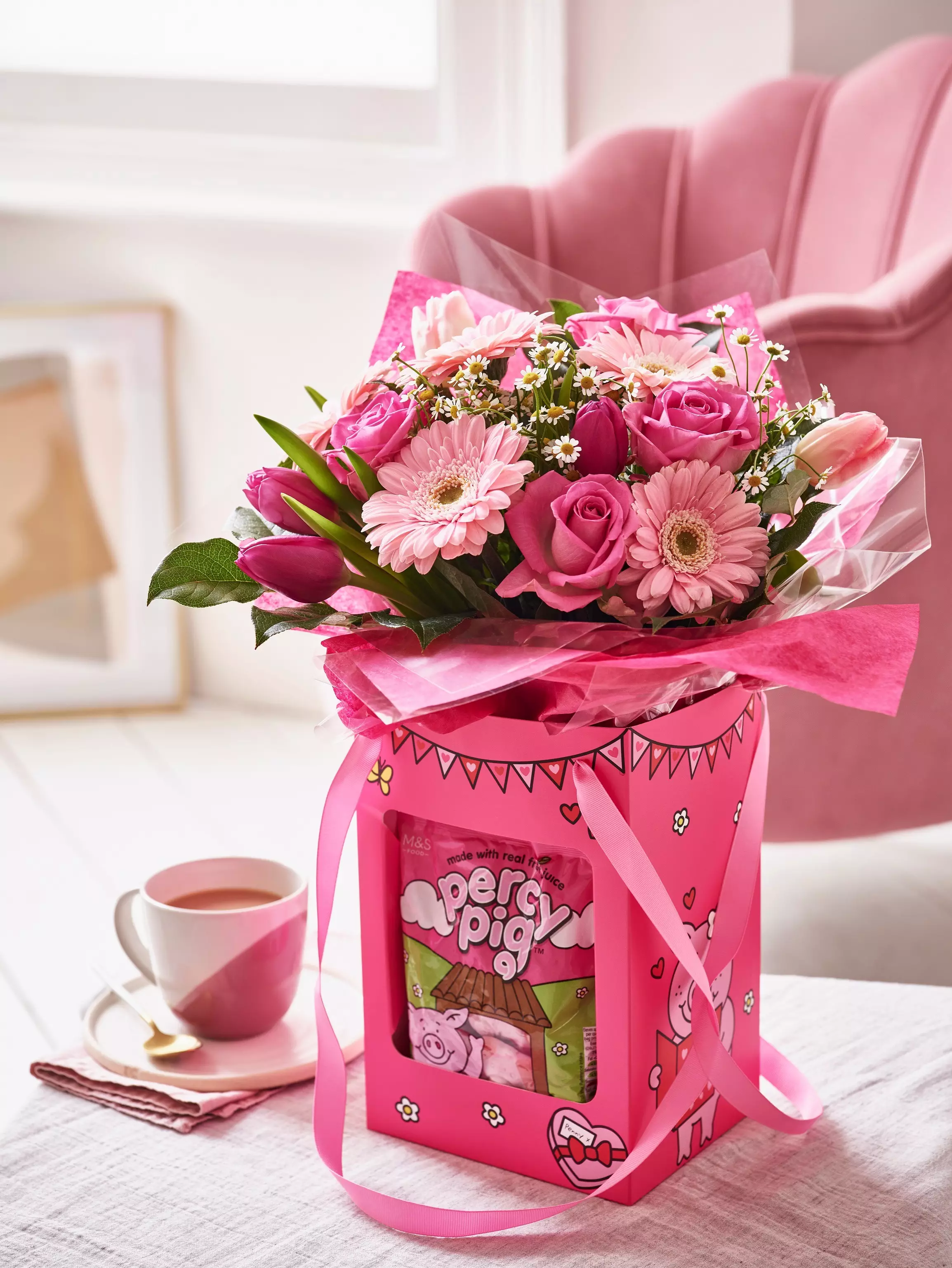 The Valentine's Percy Pig Gift Bag features a beautiful bouquet of pink flowers and Percy sweets (
