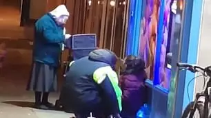 Elderly Woman Hands Out Soup To Homeless People In 3C Temperatures 