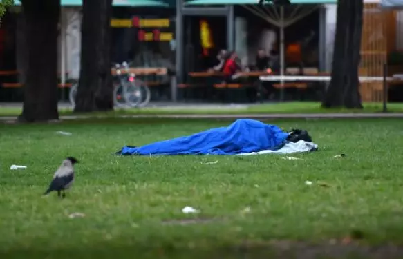 Sleeping homeless in a field