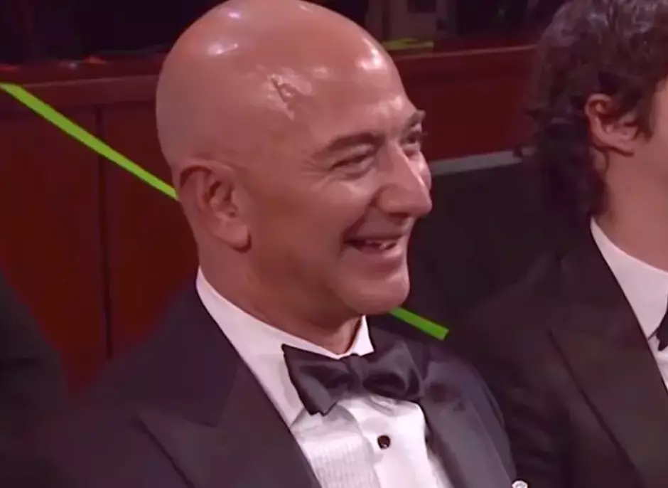 Bezos laughed along with Rock's jokes.