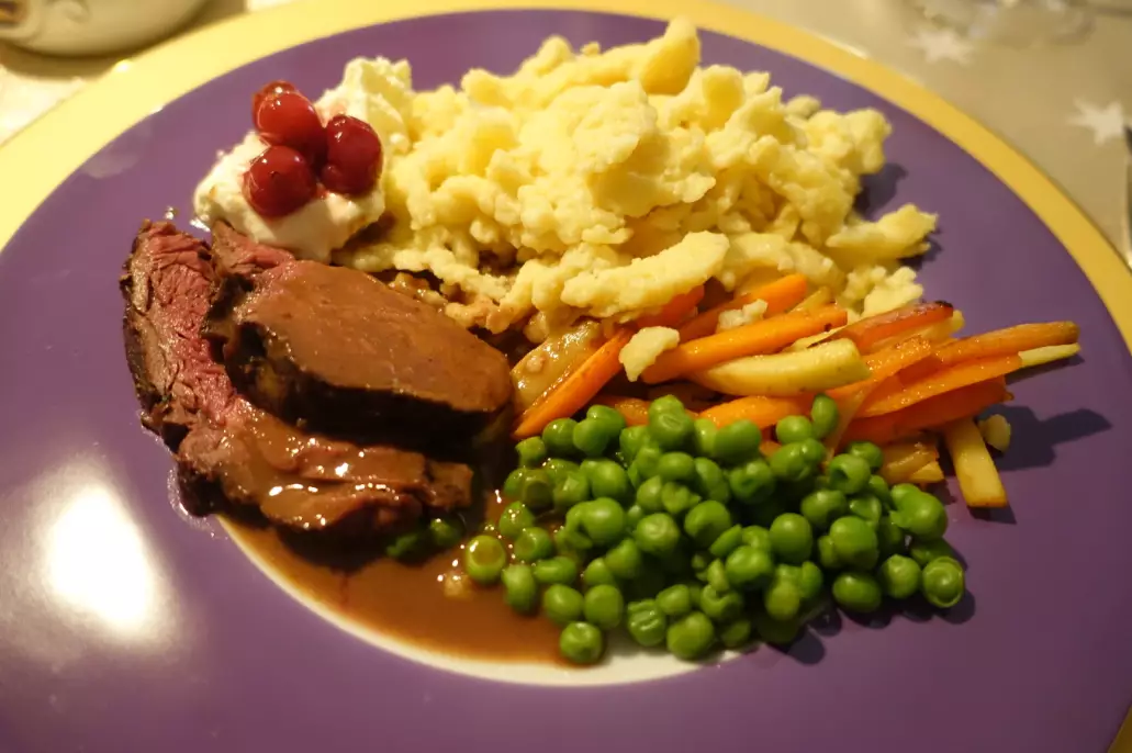 Meat served with German spaetzle noodles, vegetables and gravy.