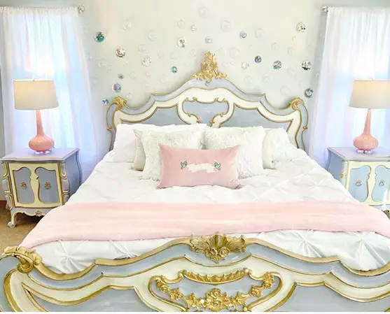 The 'Cinderella' bedroom features a royal bed frame and matching bedside tables (