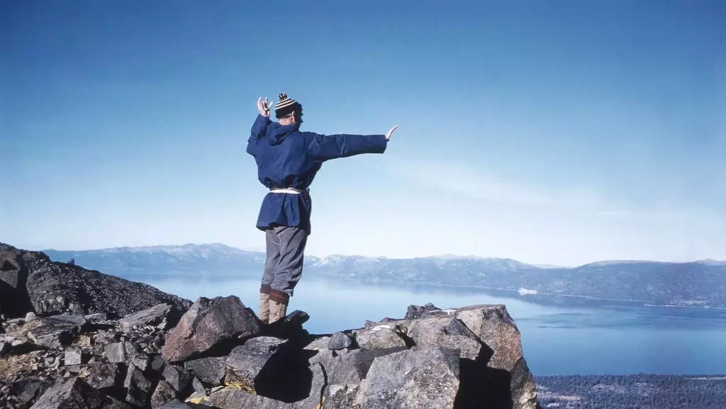 Dr King stands atop a mountain.