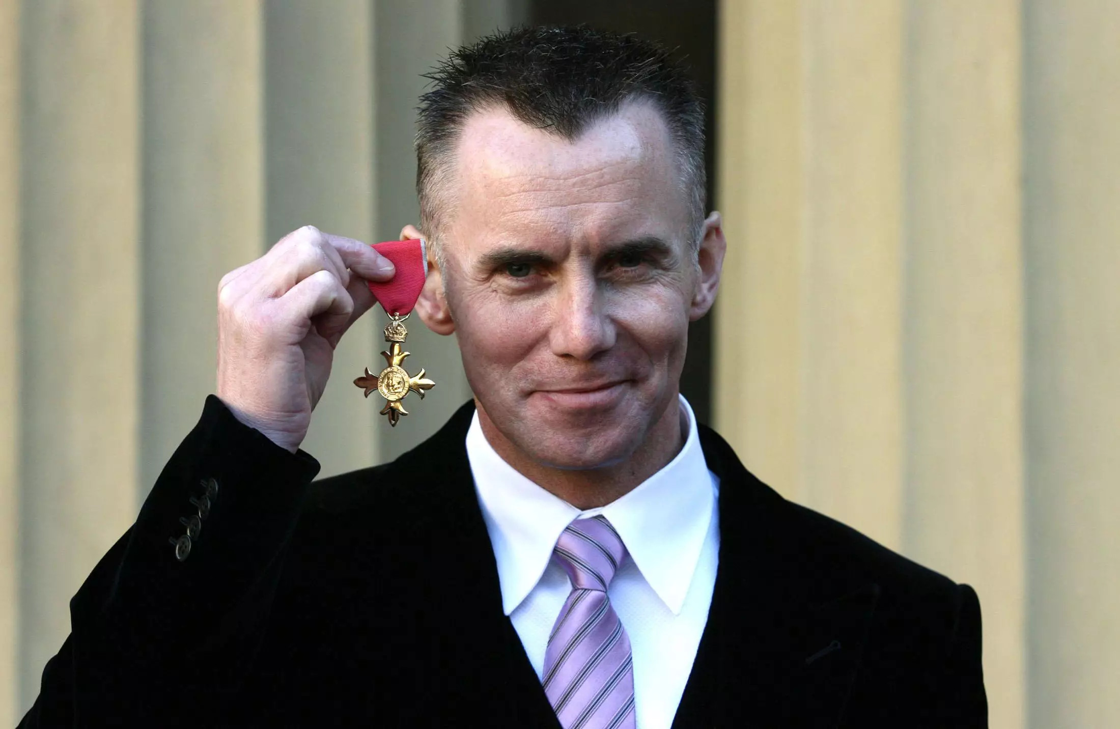 Rhodes with his OBE.