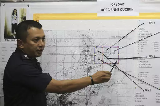 Malaysia's assistant superintendent of police shows search and rescue zones during a press briefing.