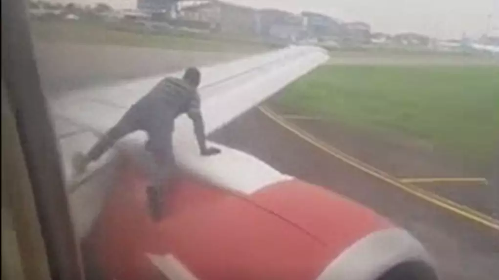 Man Climbs On Wing Of Plane As It Prepares To Take Off
