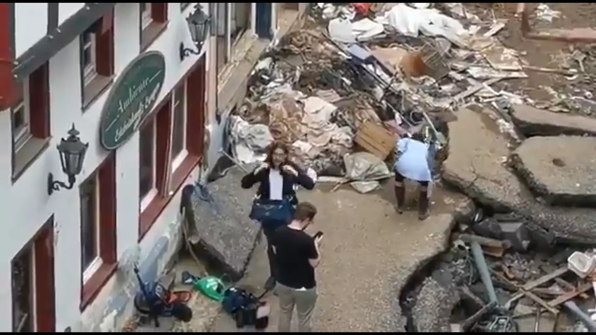 Reporter Apologises After Being Caught Muddying Herself During Flood Clean Up