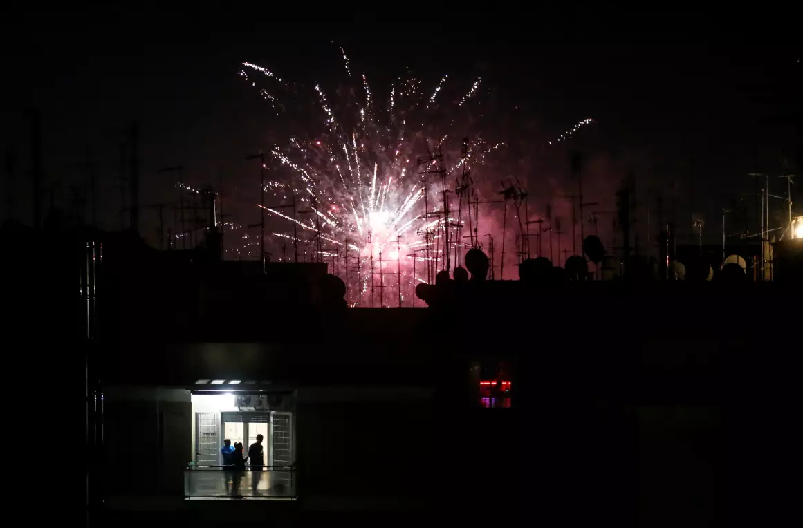 People on a balcony watch fireworks during the new year celebrations in Rome on Friday 1 January 2021.