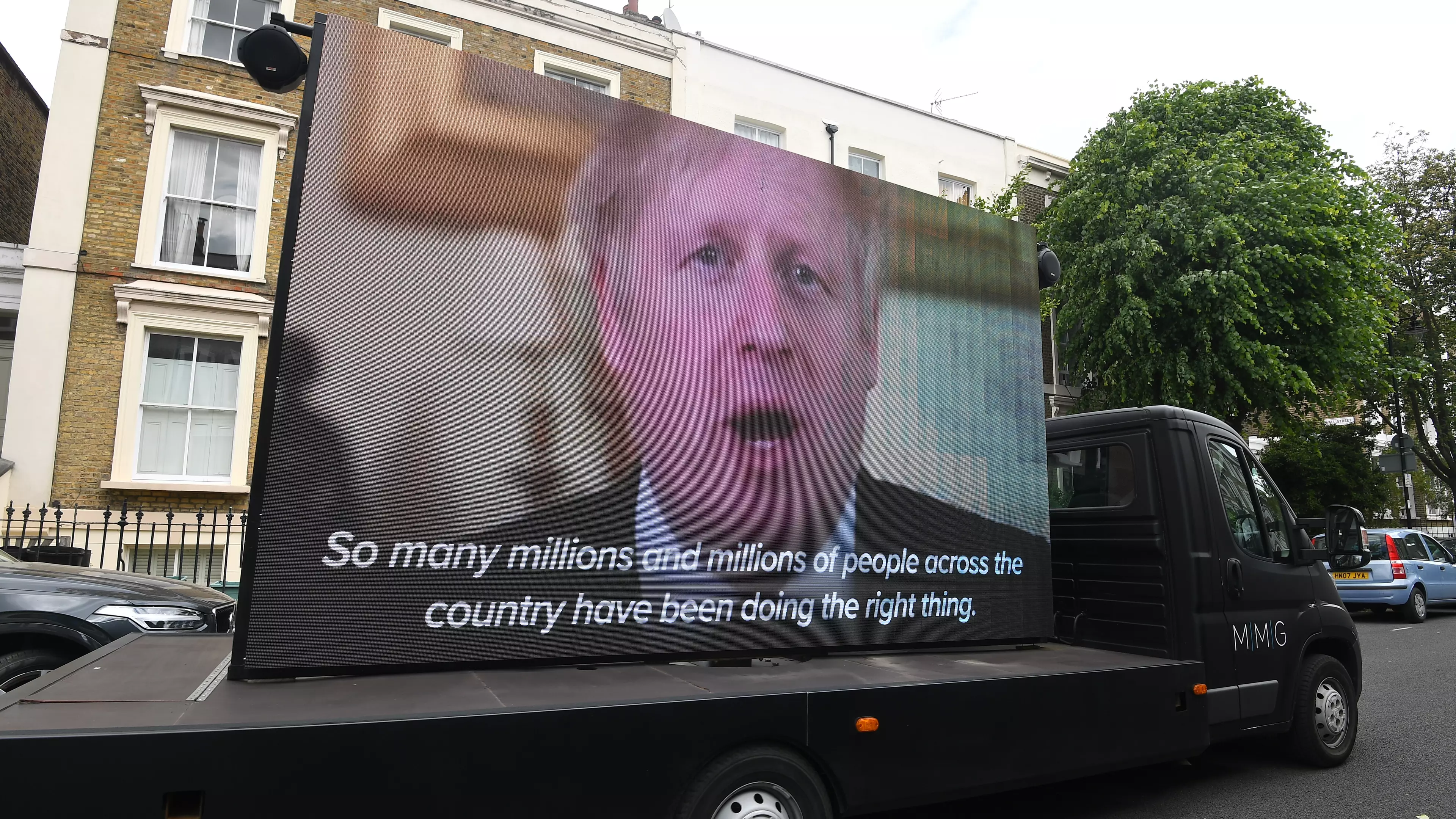Huge Screen Playing Boris Johnson's 'Stay At Home' Message Arrives Outside Dominic Cummings' House