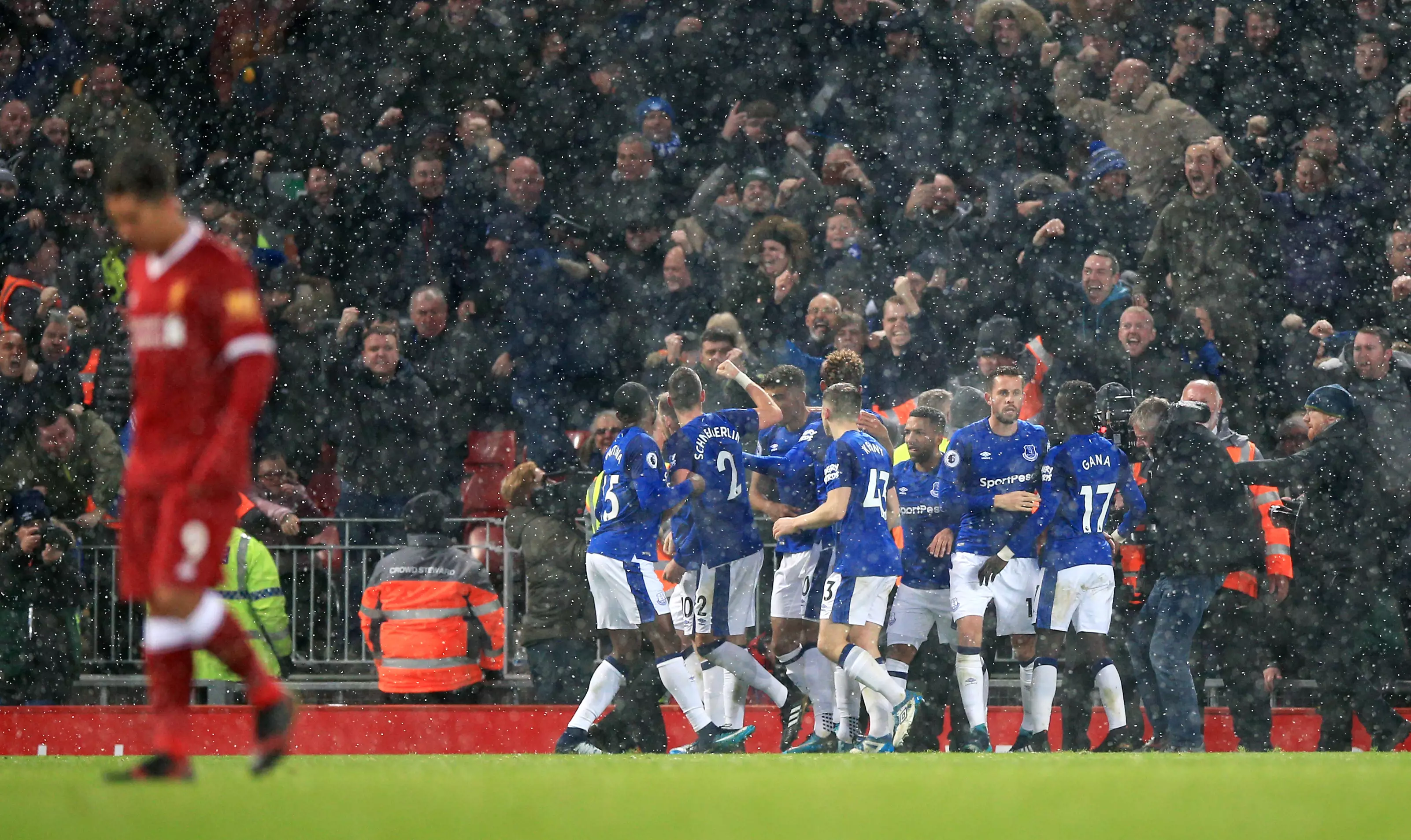 Rooney celebrates with his teammates after converting a penalty against Liverpool. Image: PA