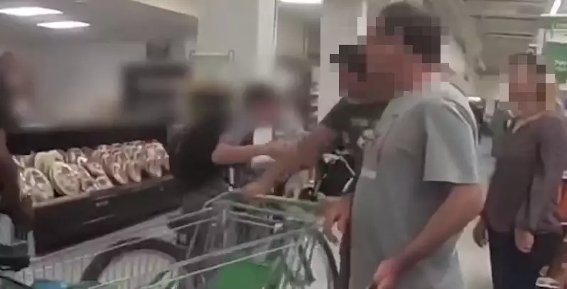 The moment one of the boys punches a shopper.