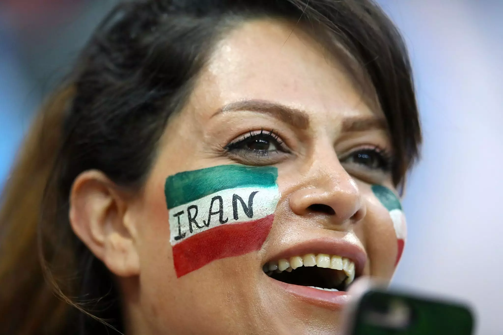 A female Iran fan watches the Spain game in the stands in Kazan. Image: PA