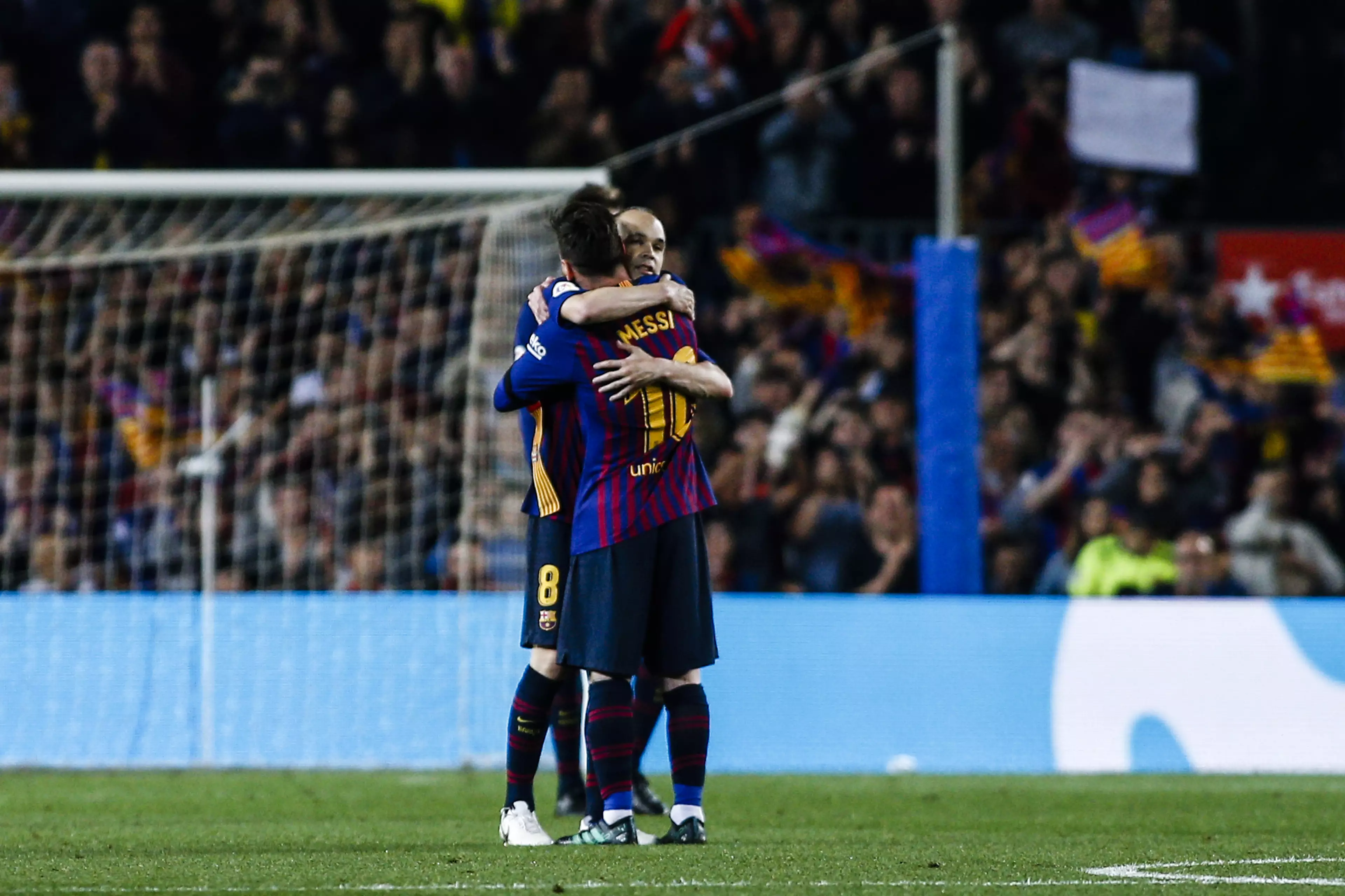 Iniesta hugs Messi on his final Camp Nou outing. Image: PA 
