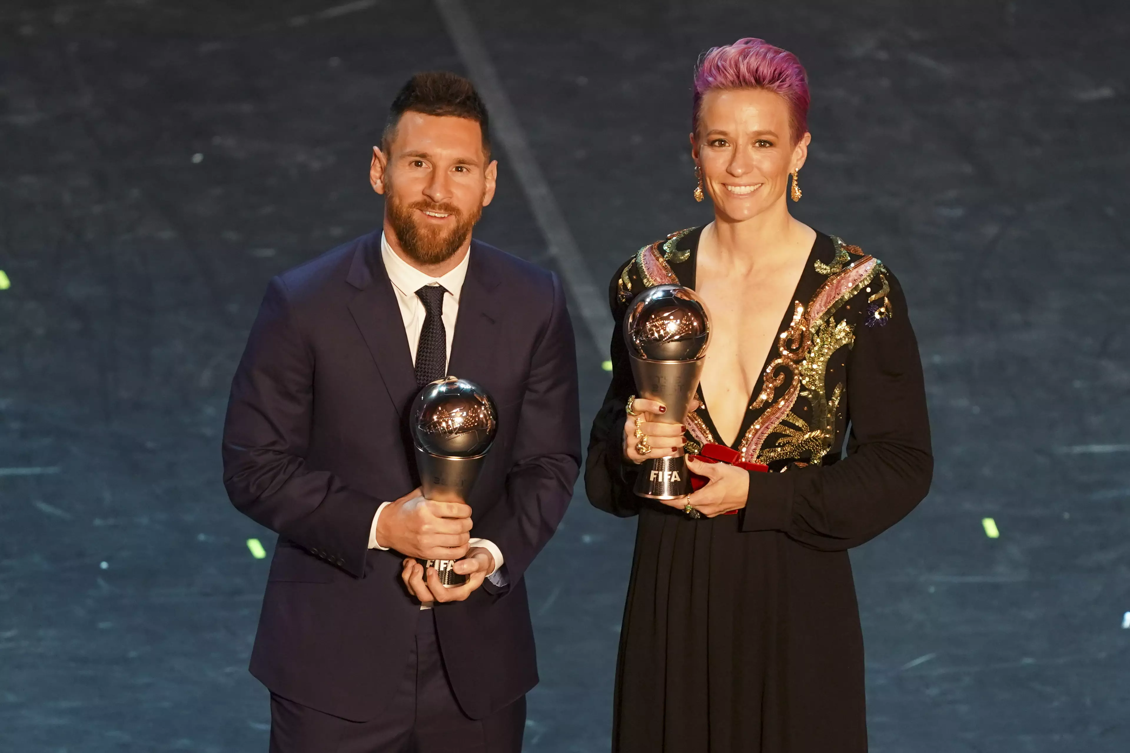 Messi with his FIFA award alongside women's winner Megan Rapinoe. Image: PA Images