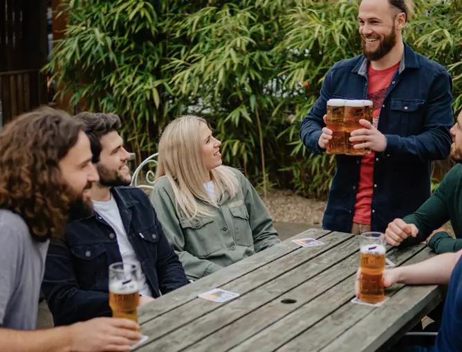 Carling's new interlocking glasses make it easy to carry four pints at once.
