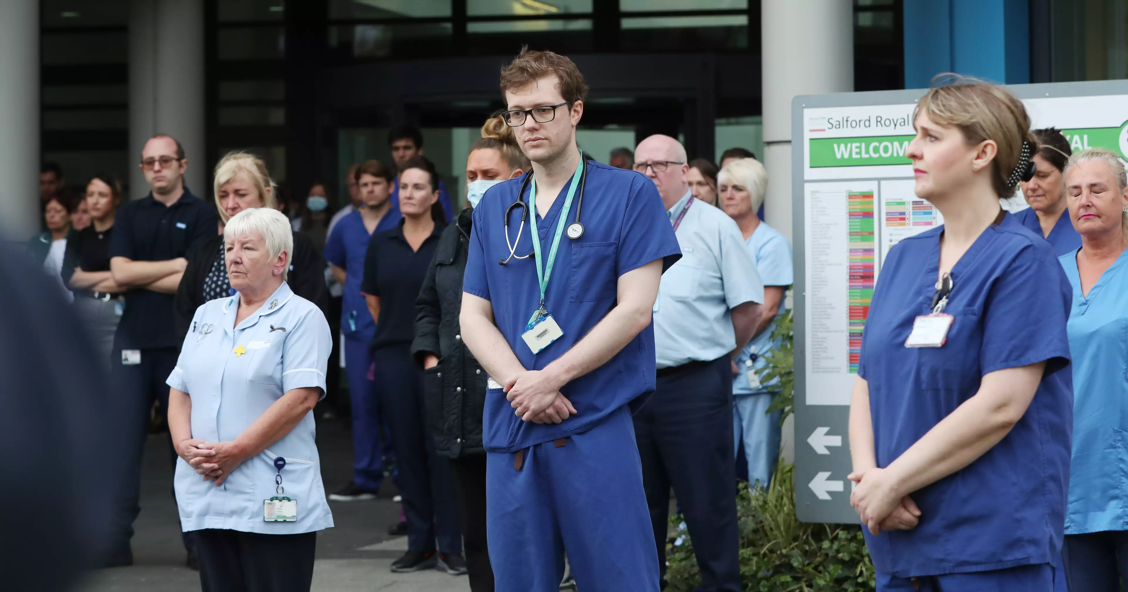 NHS staff standing side-by-side for the minute's silence.