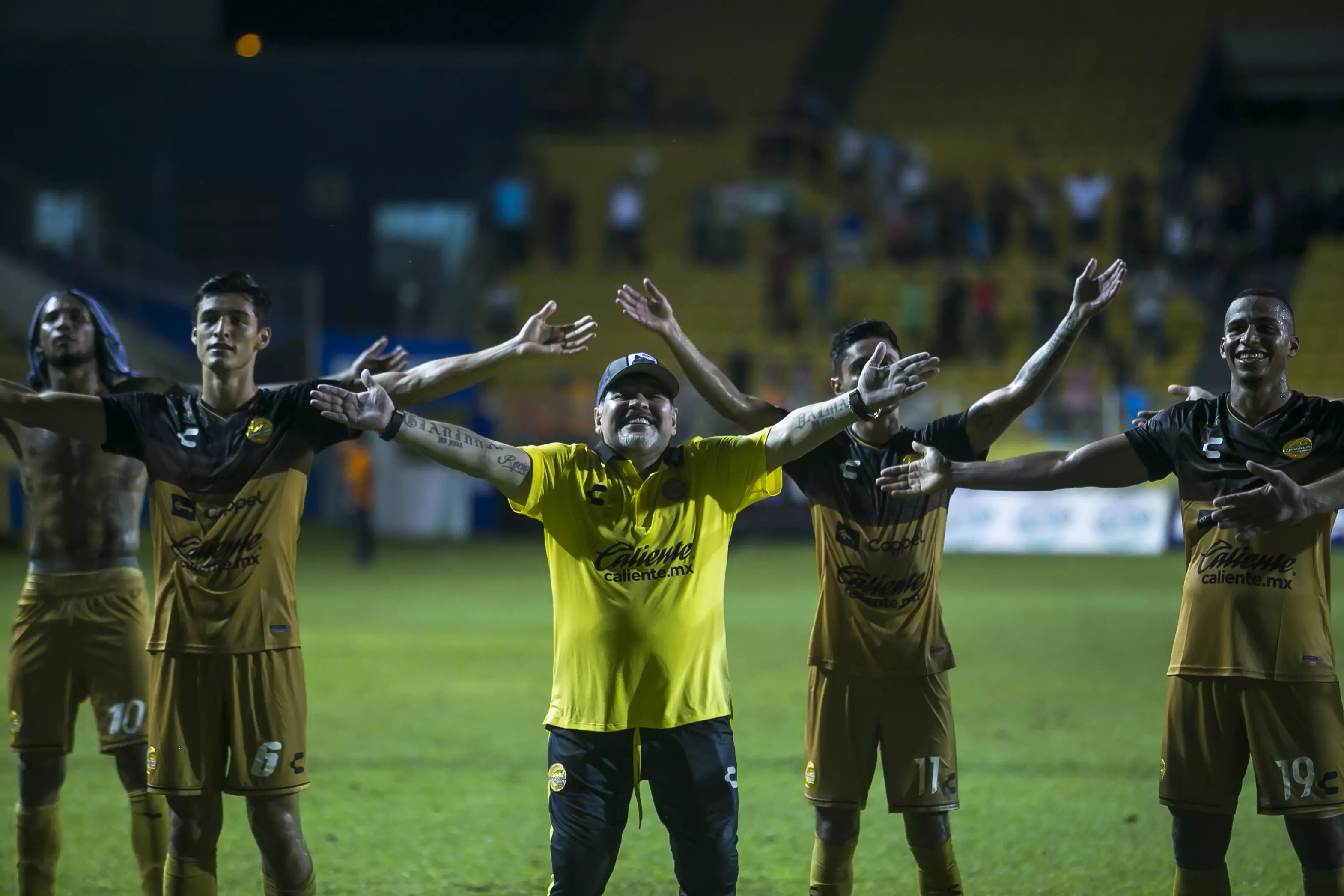 Maradona celebrating with his players in front of fans. Image: PA Images