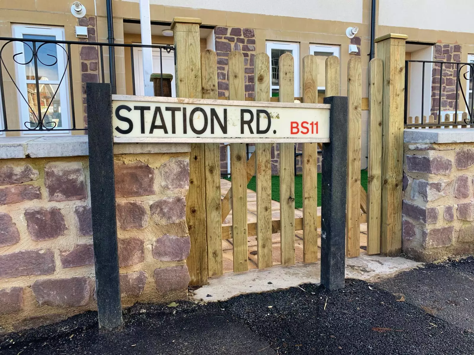 The Station Road sign blocks the gate of entry (