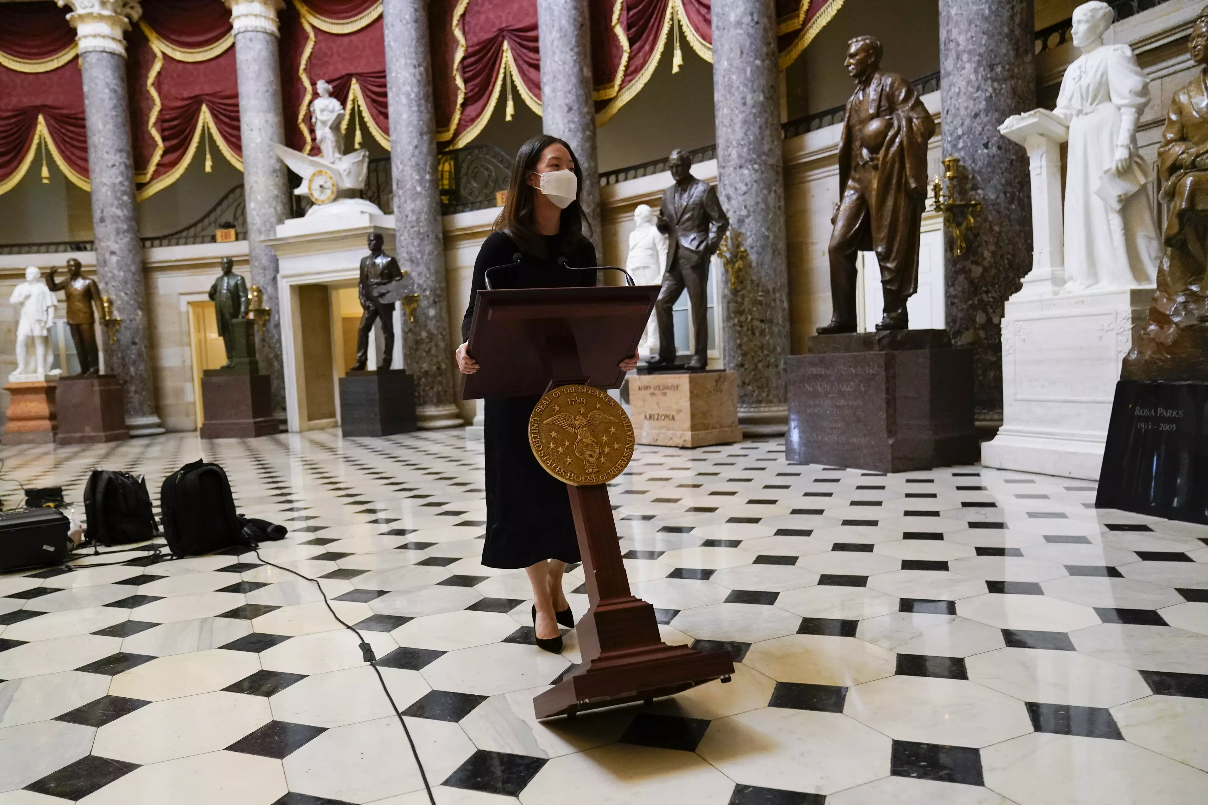 The lectern that was stolen during last week's riot is wheeled trhough Statuary Hall.