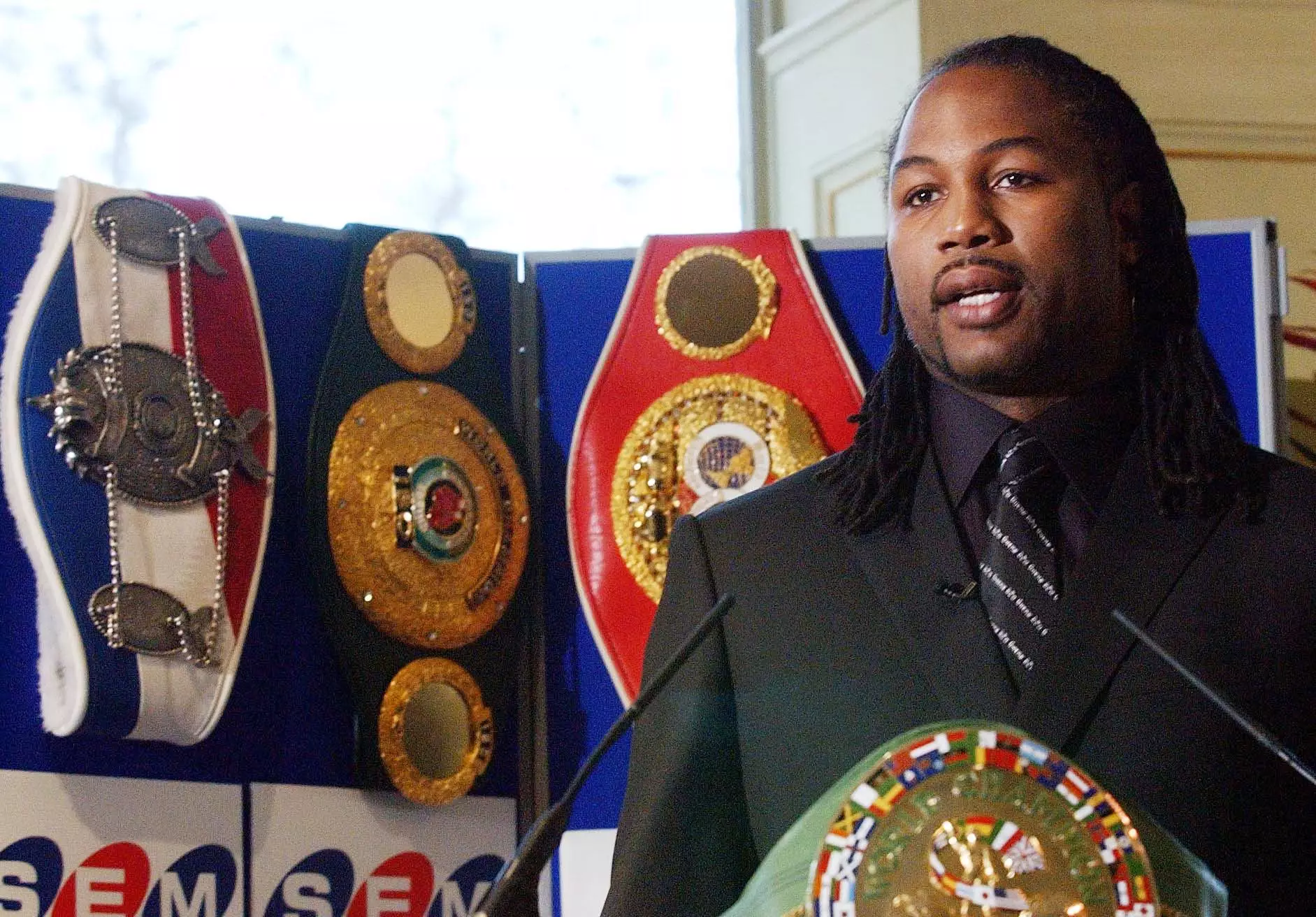 Lennox Lewis with four of the belts that made him an undisputed champions. Image: PA Images