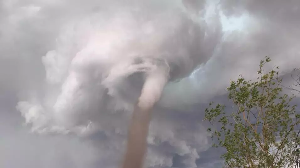 Guy Pictured Mowing His Lawn Despite Massive Tornado Behind Him 