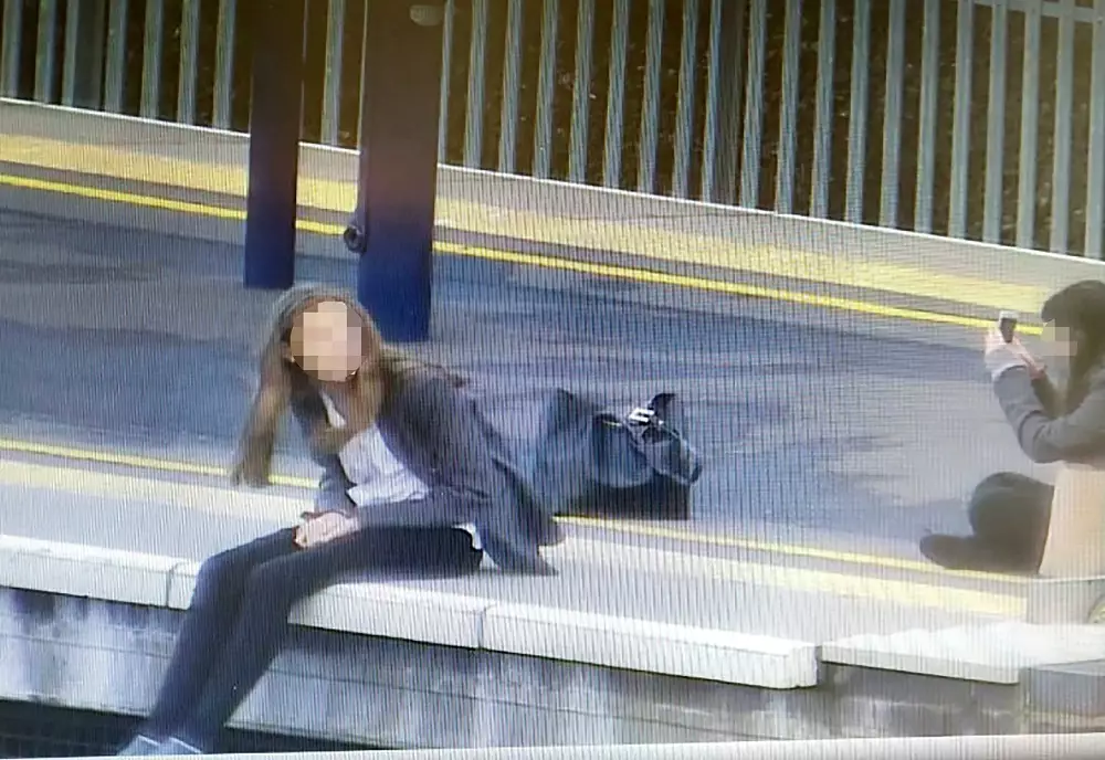Trains needed to be delayed. Here one of the girls can be seen dangling her legs from the platform.