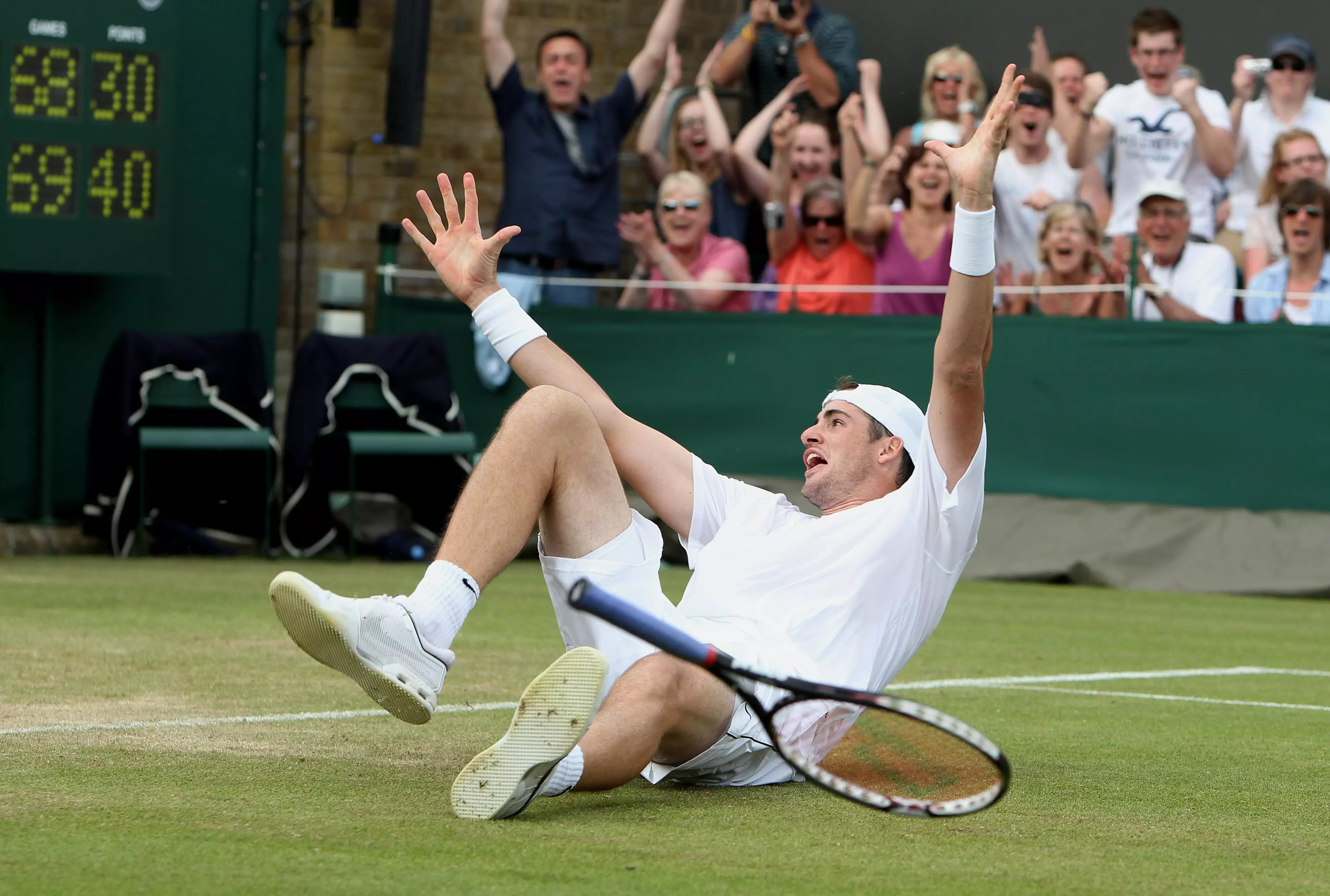 Isner drops to the ground on winning the match. Image: PA Images