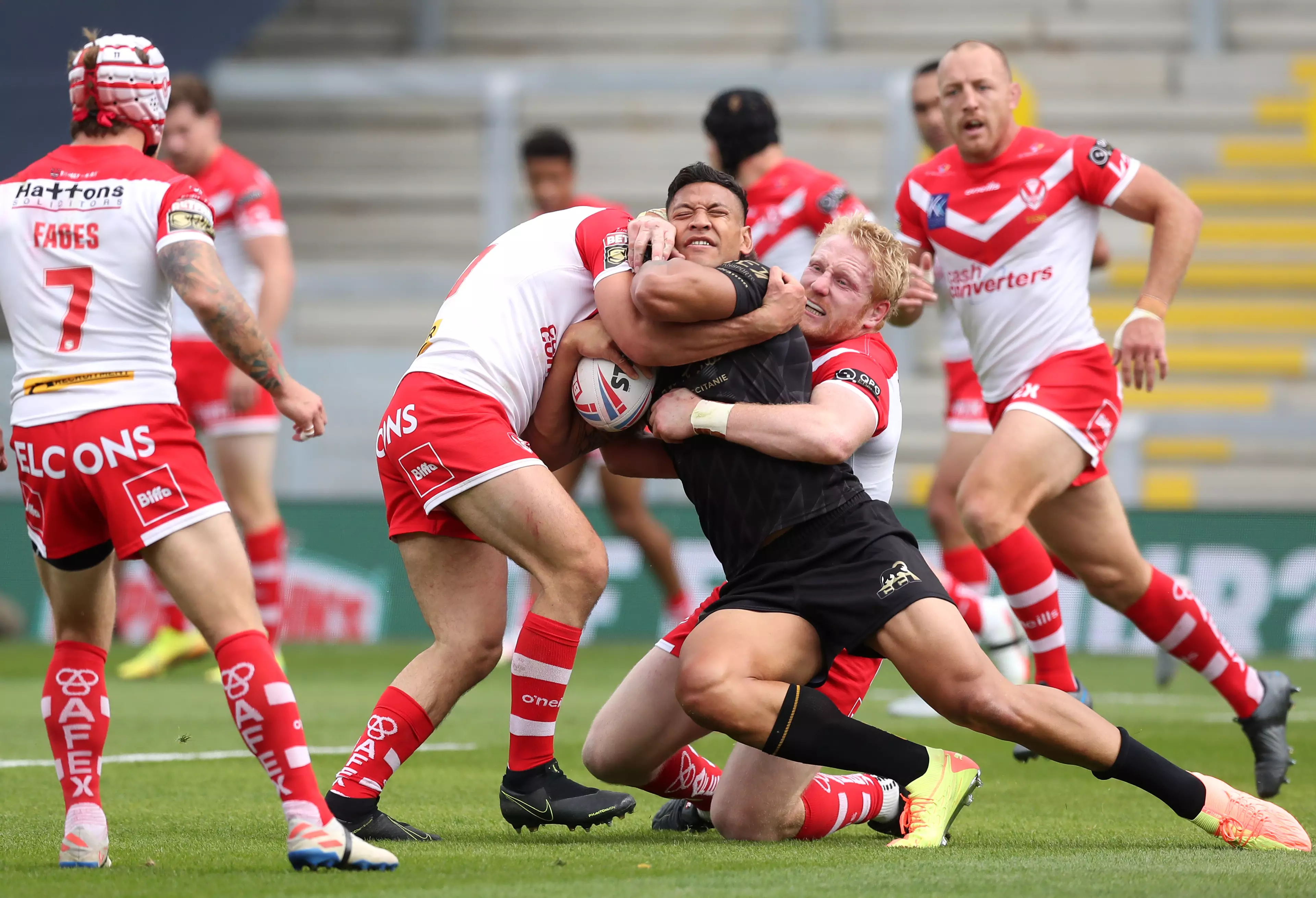 Israel Folau is tackled by St Helens players.