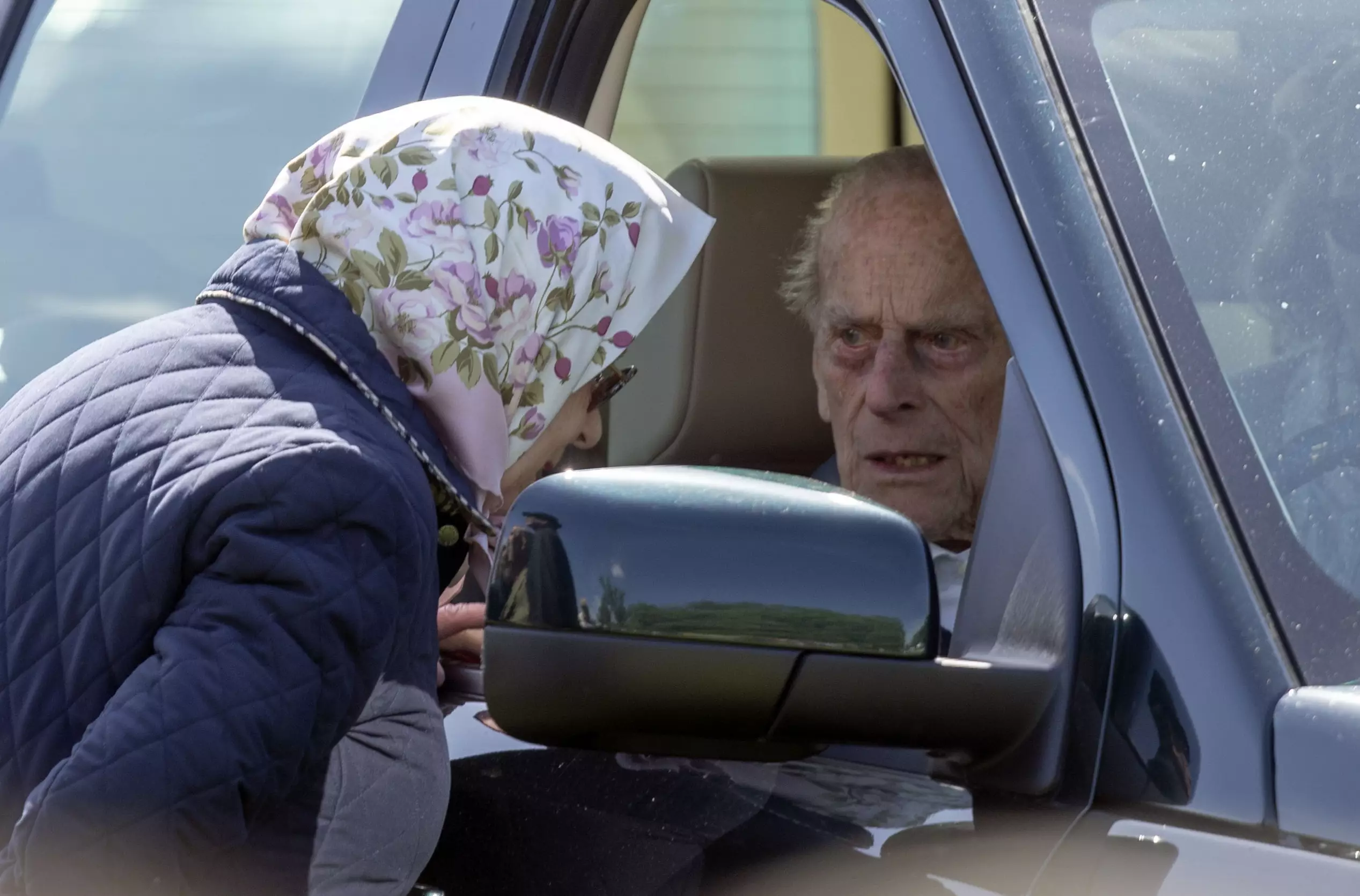 The Queen has a chat with the Duke of Edinburgh through his car window.