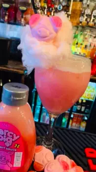 The cocktail is topped with candyfloss and a Percy Pig sweet (