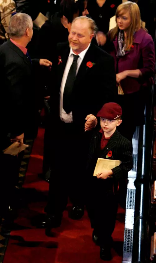 Fin, aged six, at a memorial service for his brother, wearing Jeff's beret.