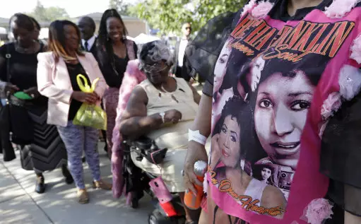 Detroit residents wait in line to enter the Greater Grace Temple for legendary singer Aretha Franklin's funeral.