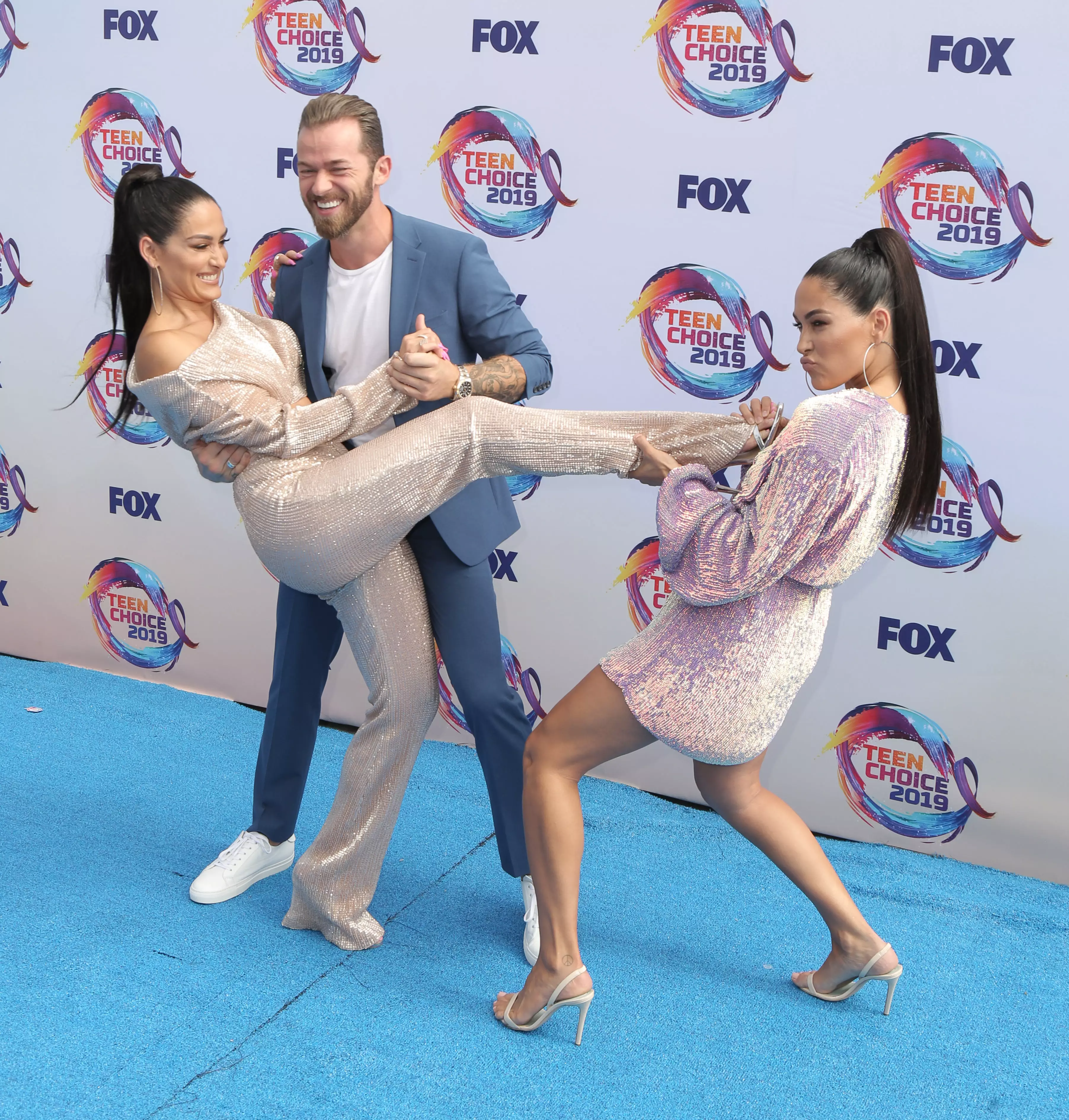 Nikki Bella, Brie Bella and Artem Chigvintsev at the Teen Choice Awards in 2019.