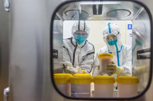 Staff members at China Center for Disease Control (CDC) receive coronavirus strains for vaccine production.