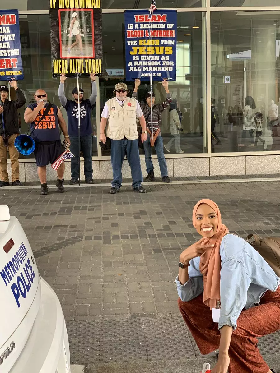 Shaymaa was told she shouldn't pose in front of the group of men, but did so anyway.